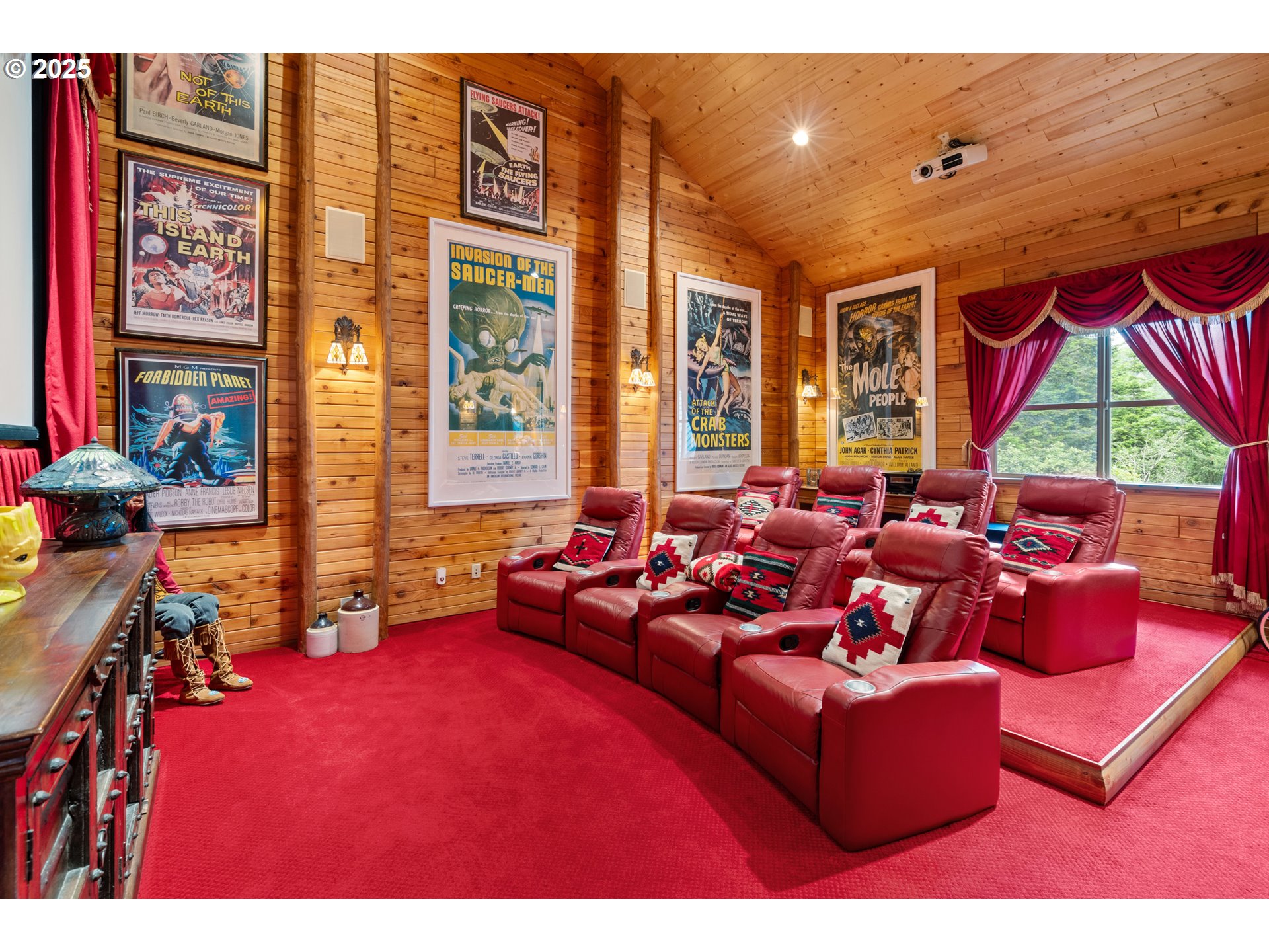 35400 Highway 101 Gold Beach, OR 97444 - Photo 38 of 46 a living room with furniture a floor to ceiling window and a flat screen tv