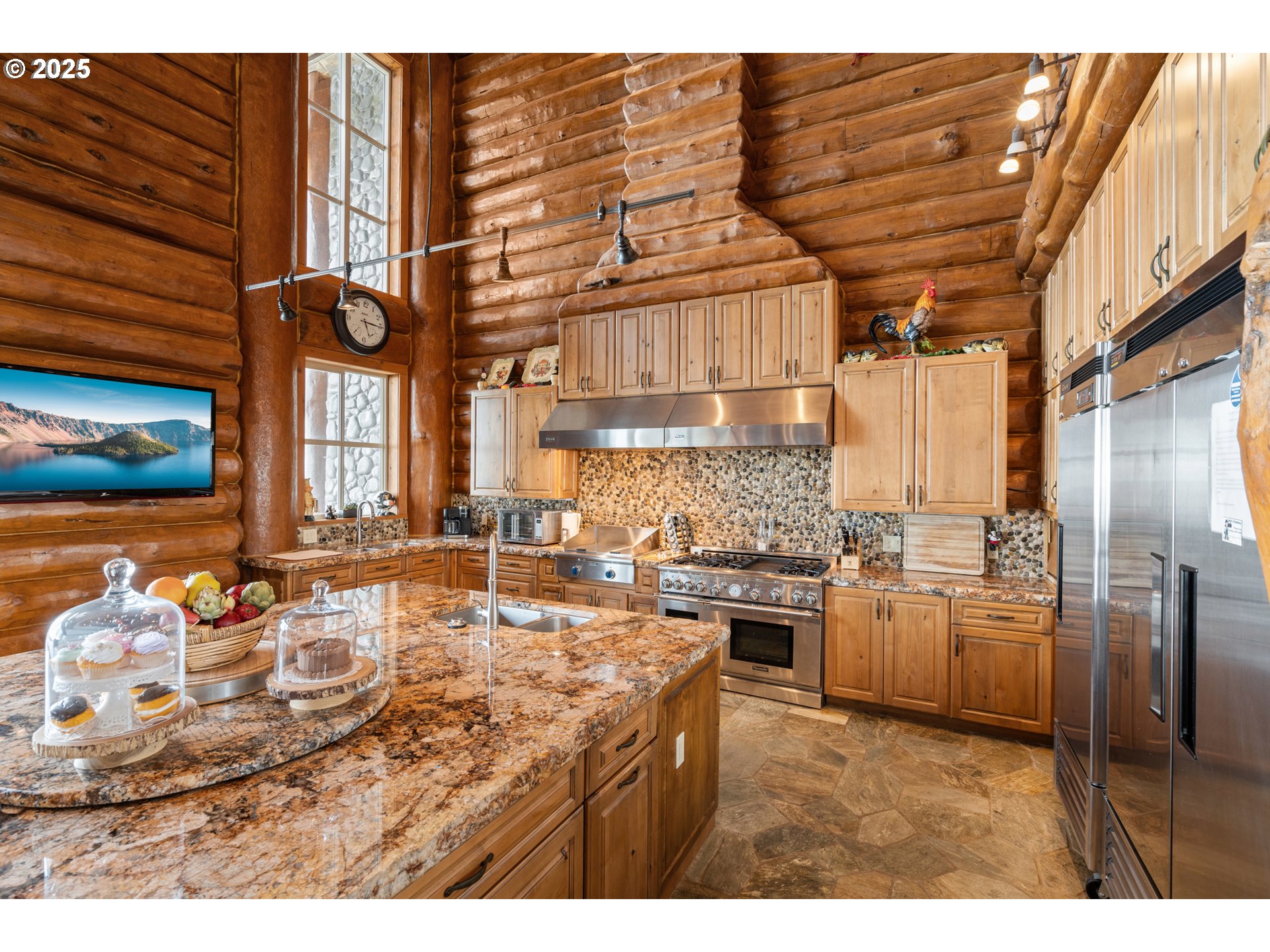 35400 Highway 101 Gold Beach, OR 97444 - Photo 9 of 46 a kitchen with kitchen island granite countertop a sink cabinets and stainless steel appliances