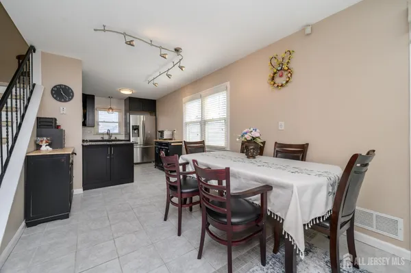 a view of a dining room with furniture and a kitchen