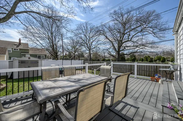 a view of a deck with furniture and trees