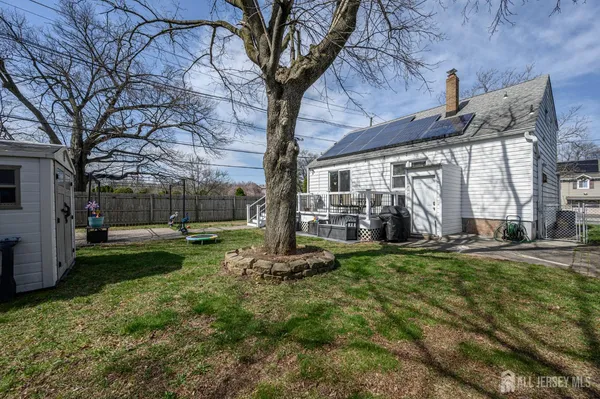 a backyard of a house with barbeque oven and table and chairs