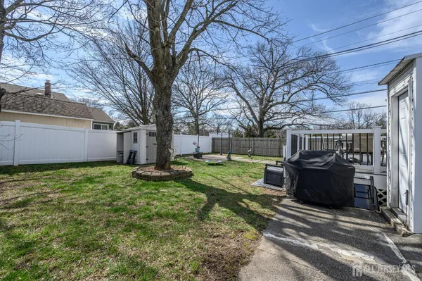 a view of a backyard with large trees