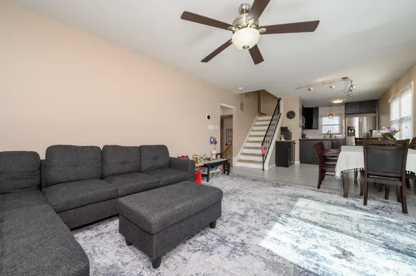 a living room with furniture and kitchen view