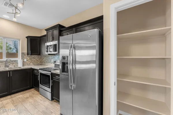 a kitchen with a refrigerator and a sink