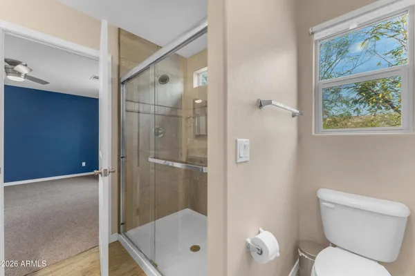 a bathroom with a shower a toilet and a sink
