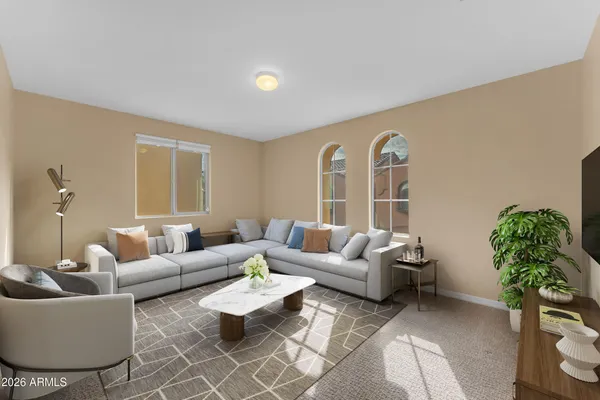a living room with furniture and a potted plant