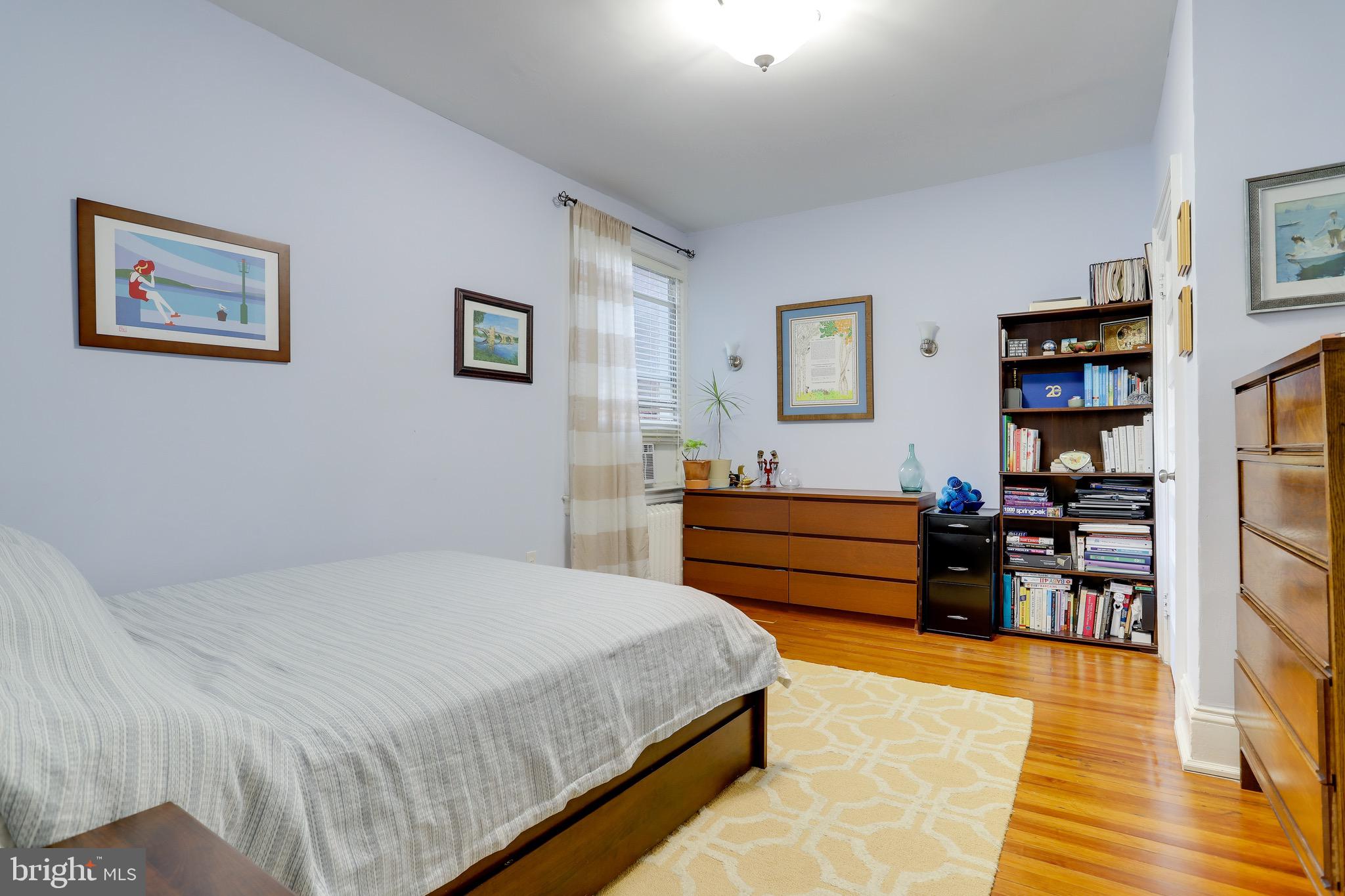 1519 Park Road Northwest, Unit 203 Washington, DC 20010 - Photo 14 of 63 a bedroom with a bed and furniture