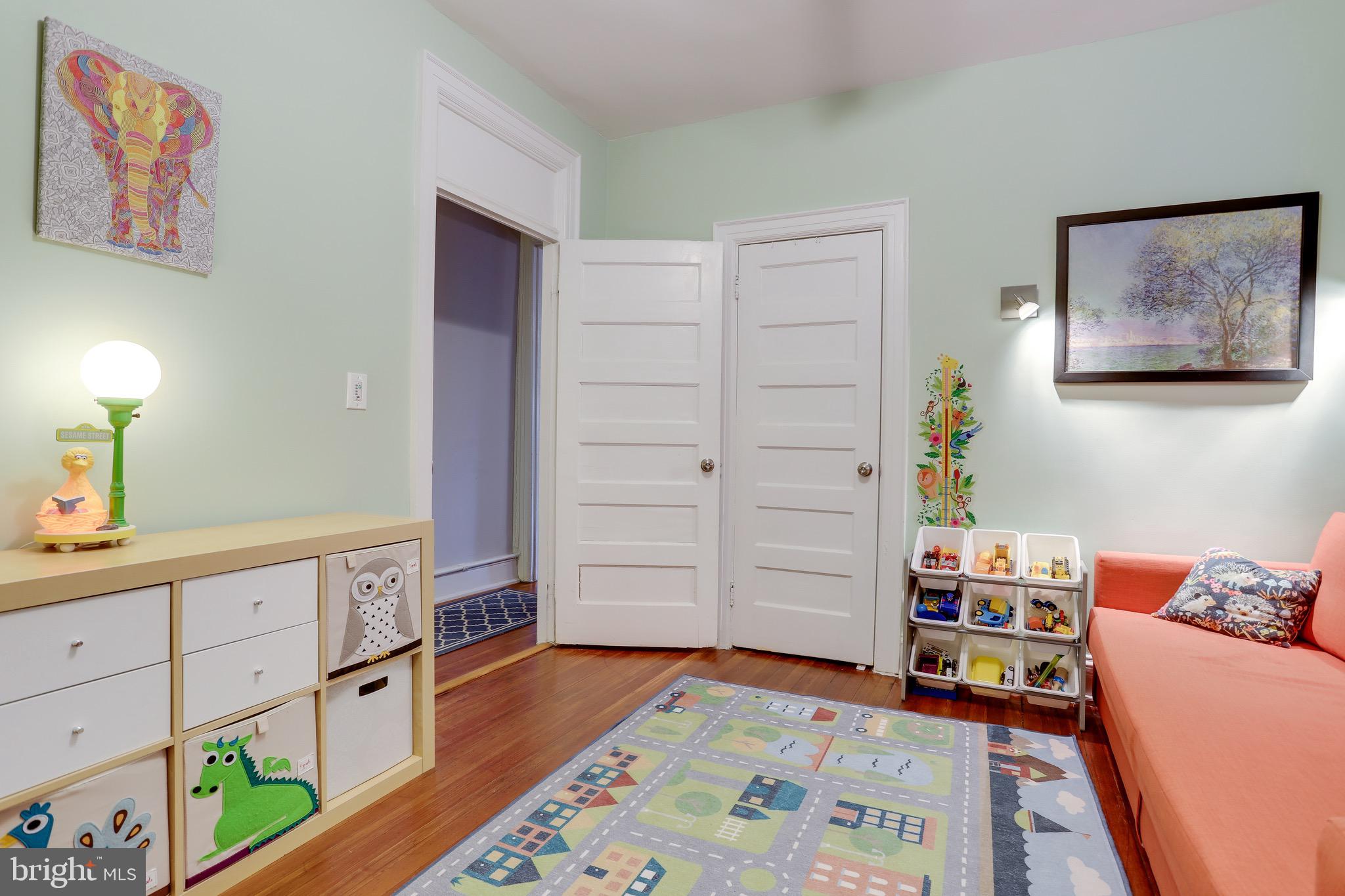 1519 Park Road Northwest, Unit 203 Washington, DC 20010 - Photo 22 of 63 a room with furniture and wooden floor