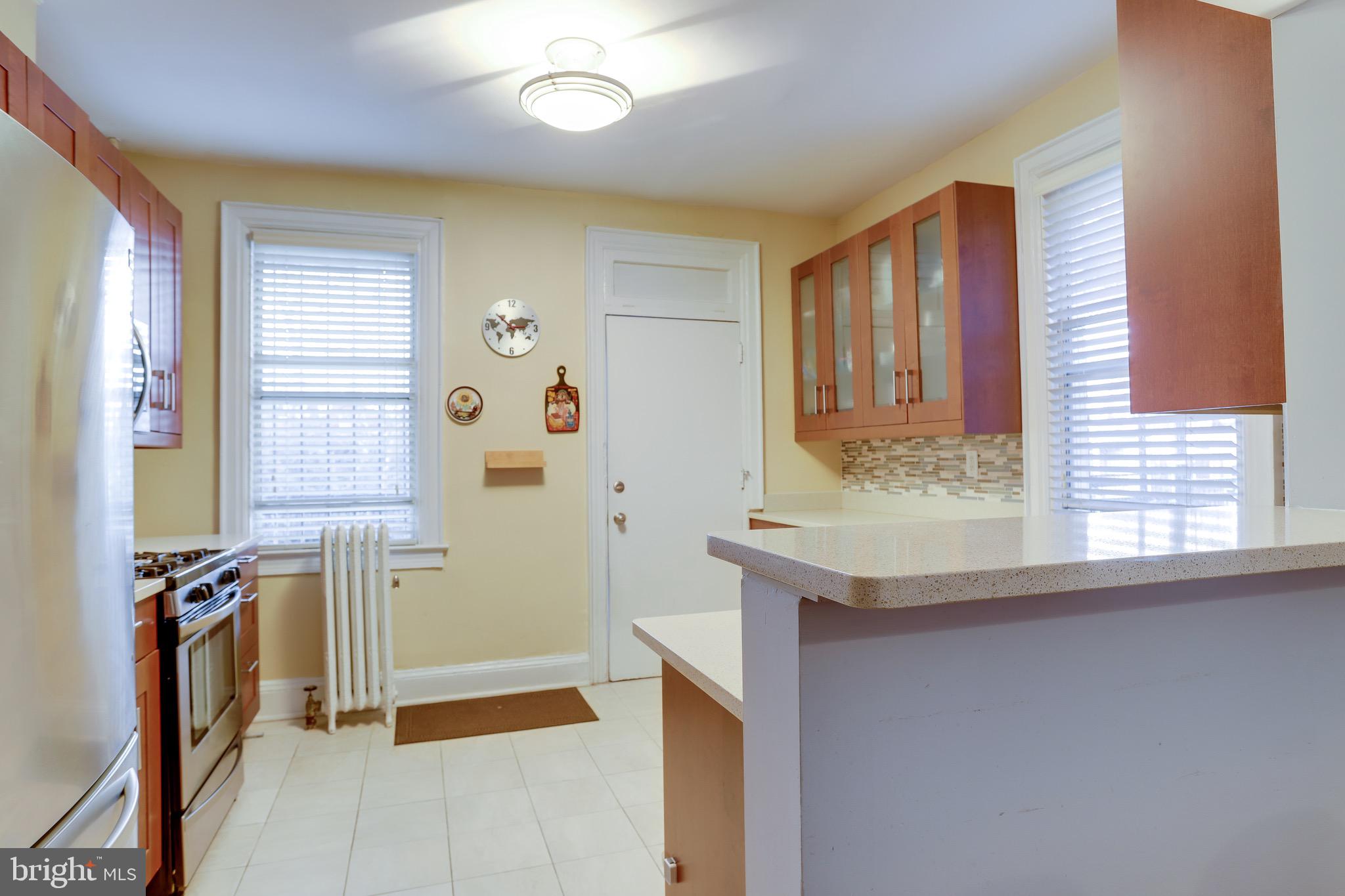 1519 Park Road Northwest, Unit 203 Washington, DC 20010 - Photo 40 of 63 a bathroom with a granite countertop sink and a mirror