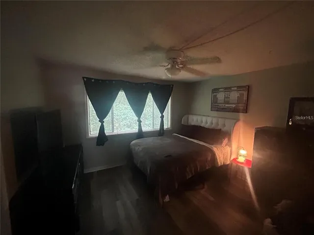 a bedroom with a bed next to a window