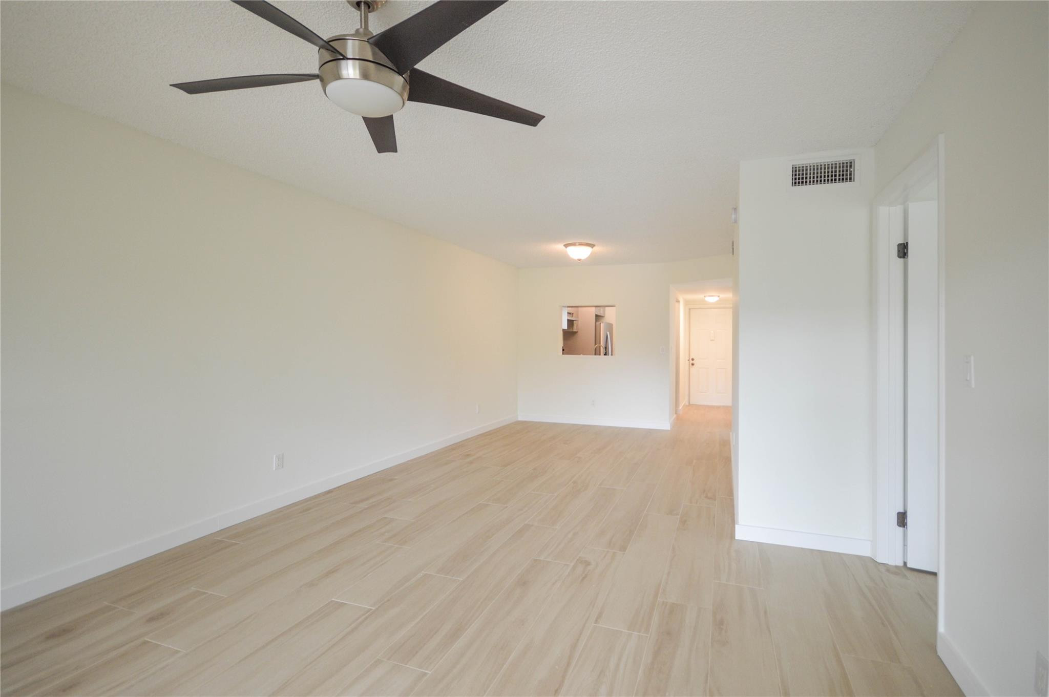 3151 Southeast Aster Lane, Unit 1301 Stuart, FL 34994 - Photo 12 of 30 wooden floor in an empty room with a window