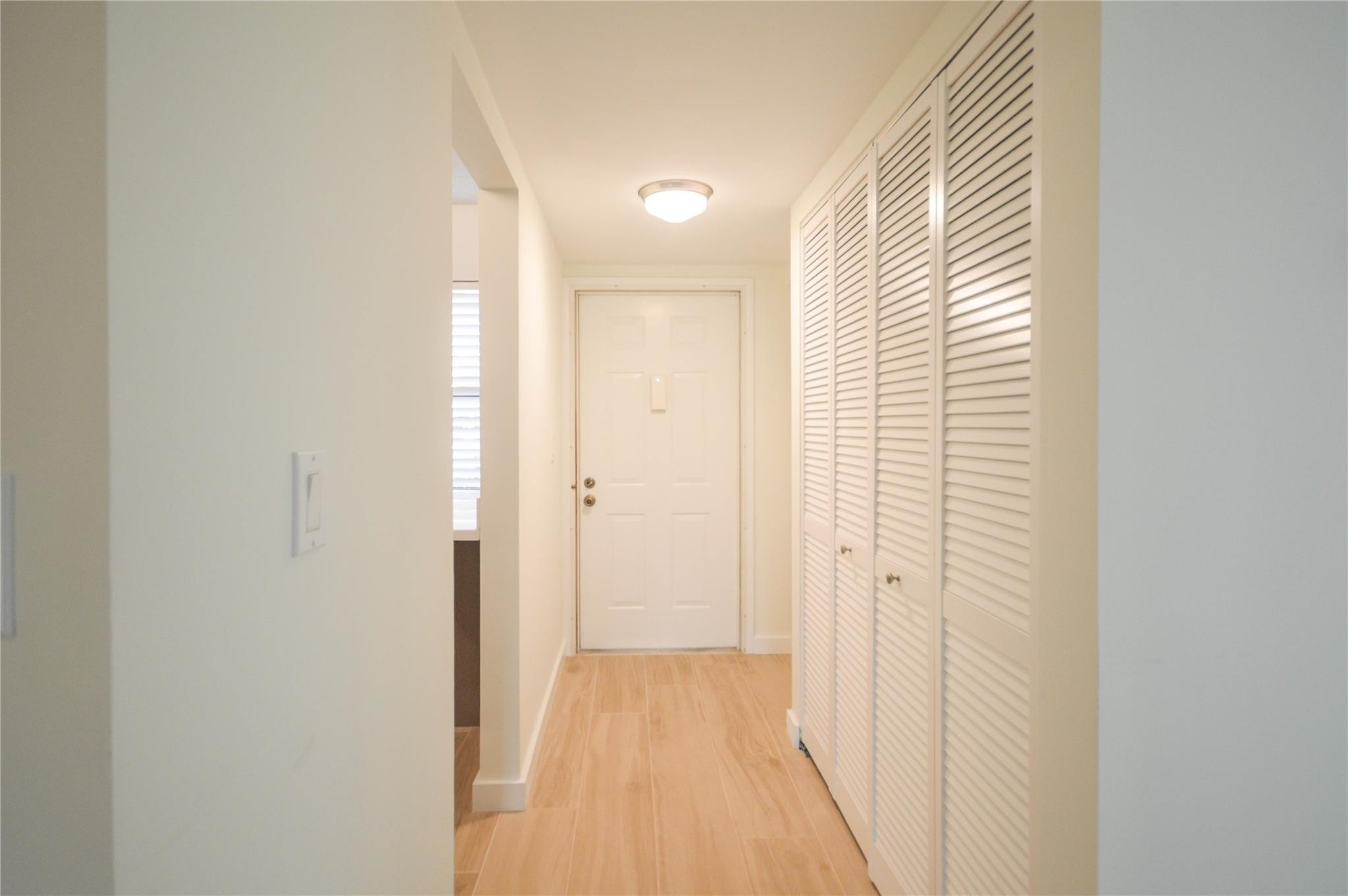 3151 Southeast Aster Lane, Unit 1301 Stuart, FL 34994 - Photo 16 of 30 a view of a hallway with wooden floor and a bathroom