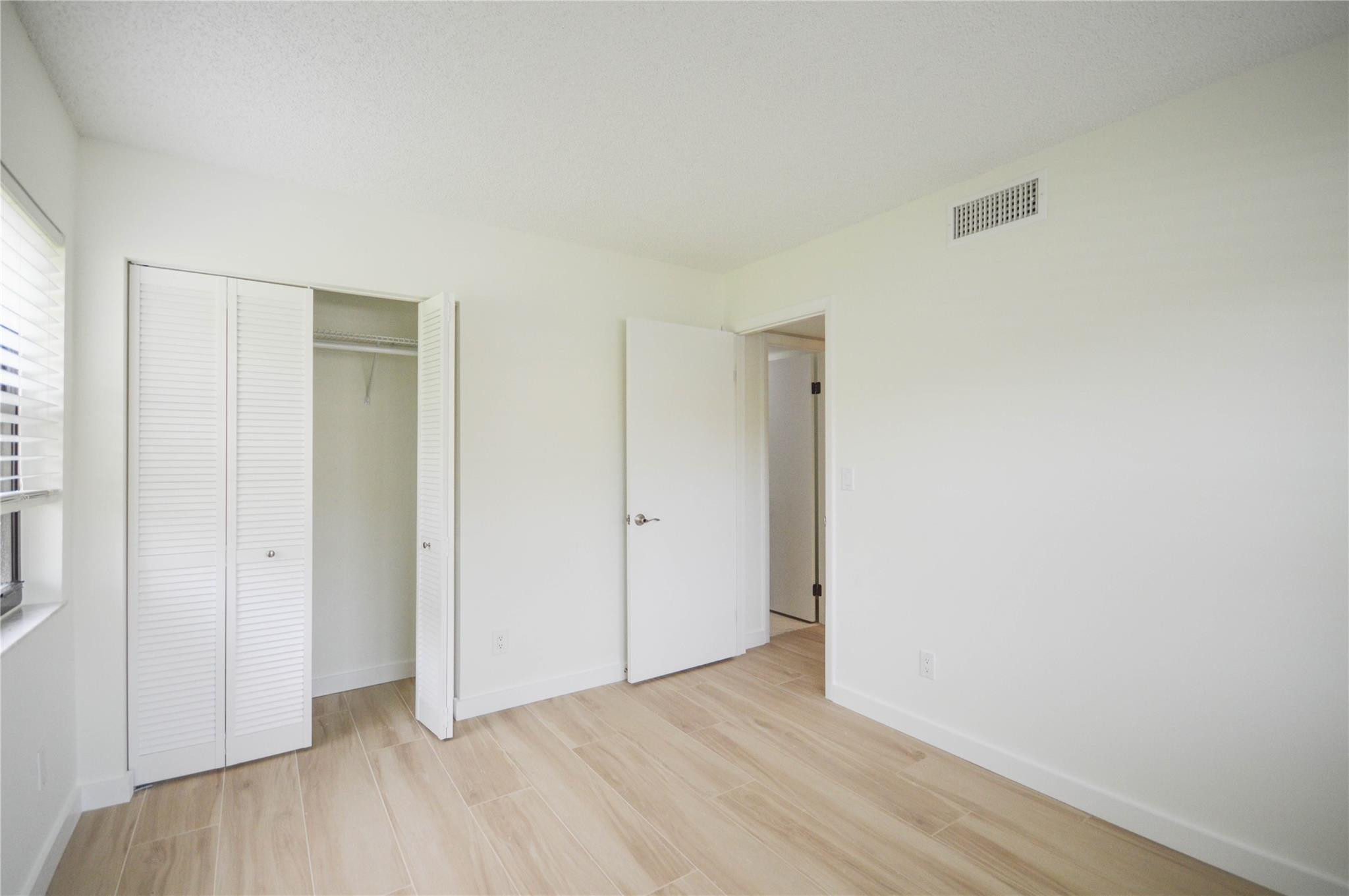 3151 Southeast Aster Lane, Unit 1301 Stuart, FL 34994 - Photo 18 of 30 a view of an empty room with wooden floor