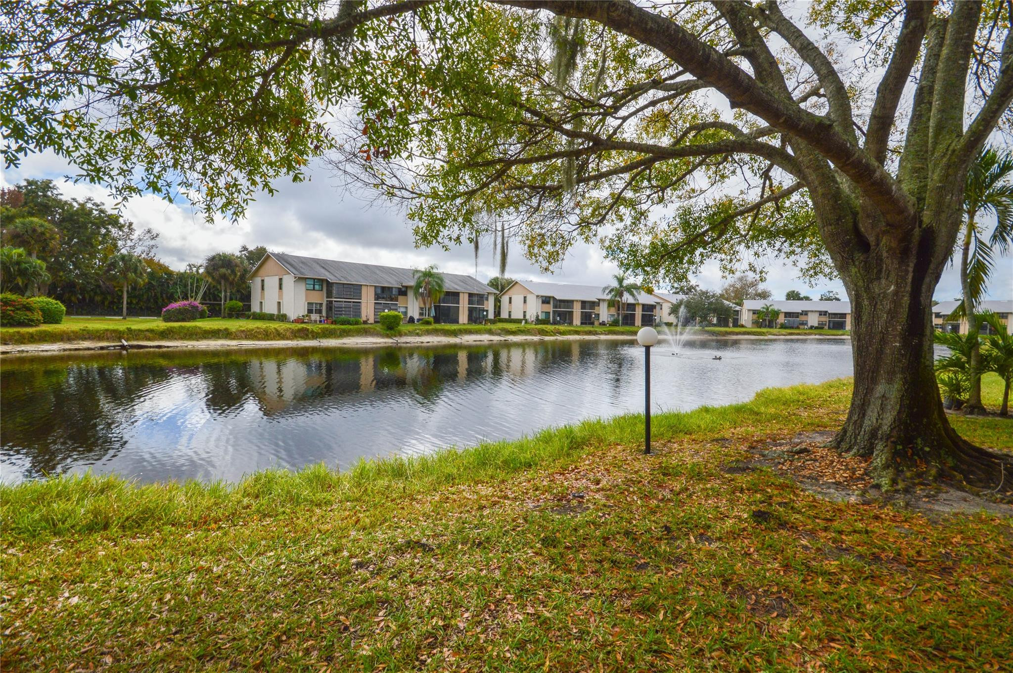 3151 Southeast Aster Lane, Unit 1301 Stuart, FL 34994 - Photo 23 of 30 a view of a lake with a house in the background