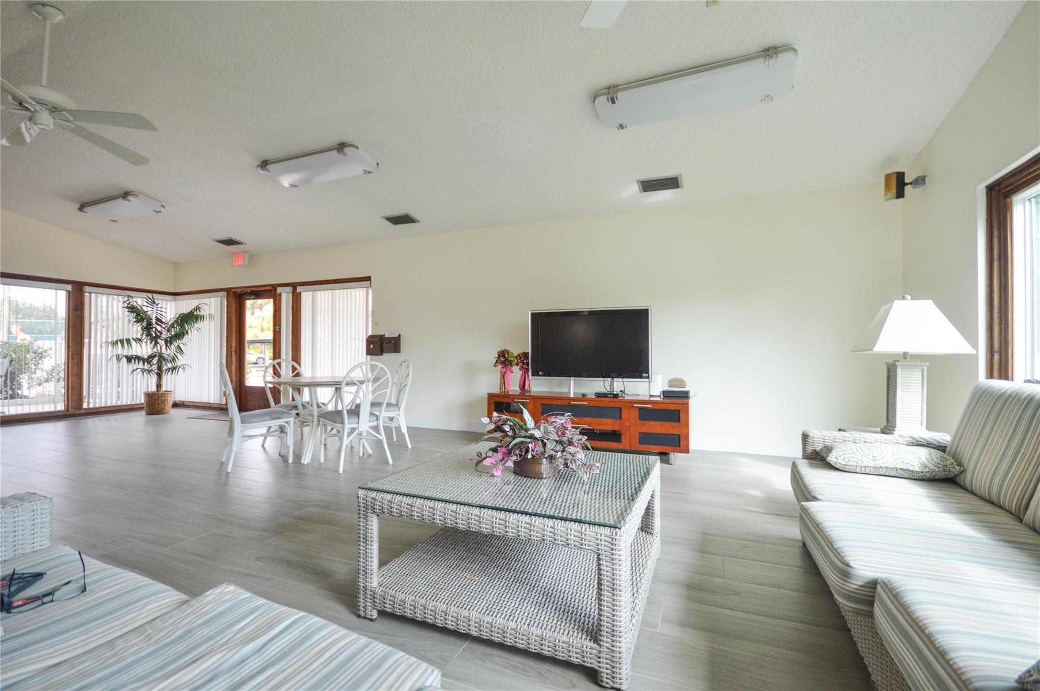 3151 Southeast Aster Lane, Unit 1301 Stuart, FL 34994 - Photo 26 of 30 a living room with furniture and a flat screen tv