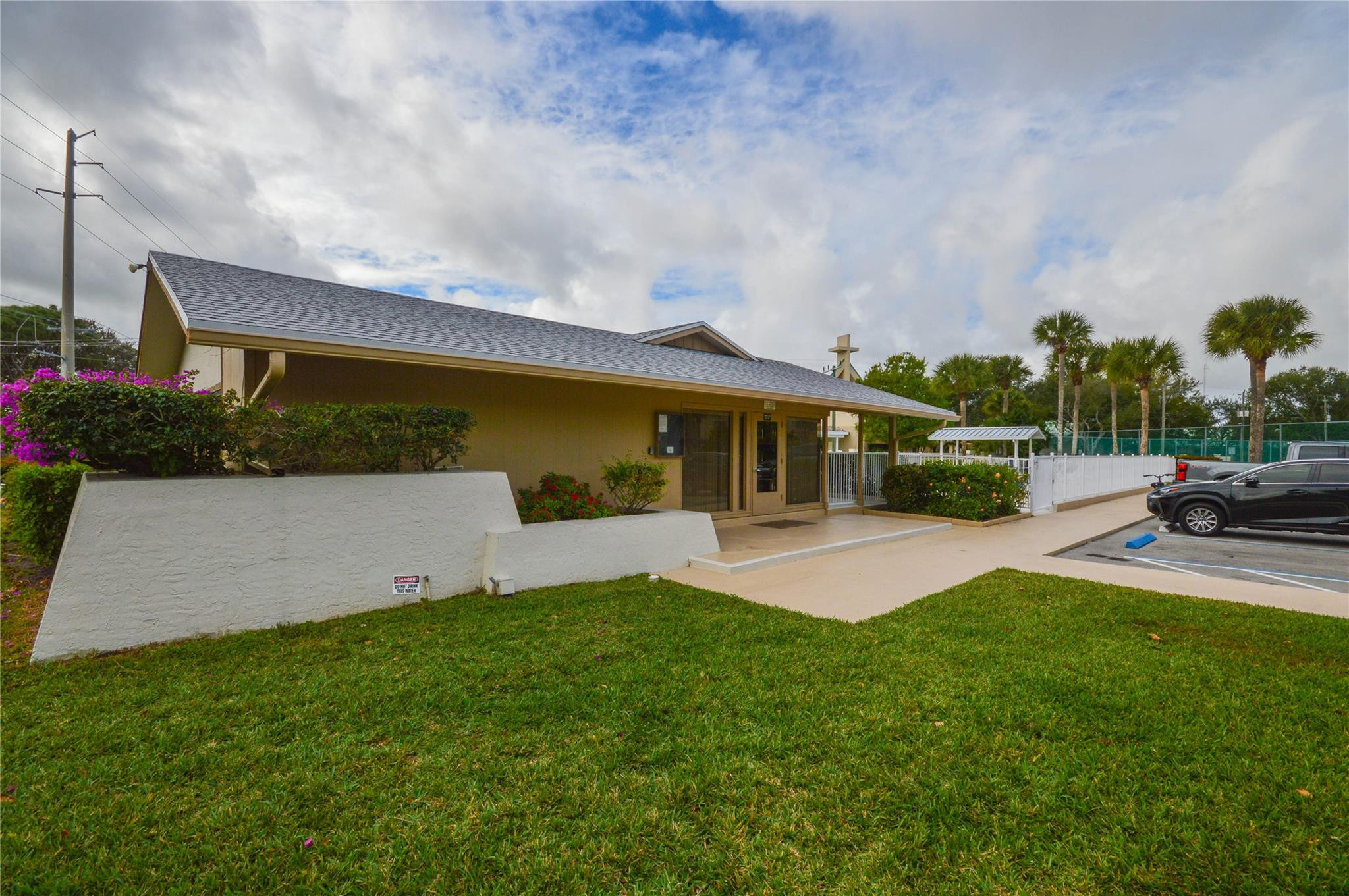 3151 Southeast Aster Lane, Unit 1301 Stuart, FL 34994 - Photo 27 of 30 a view of a house with pool and a yard
