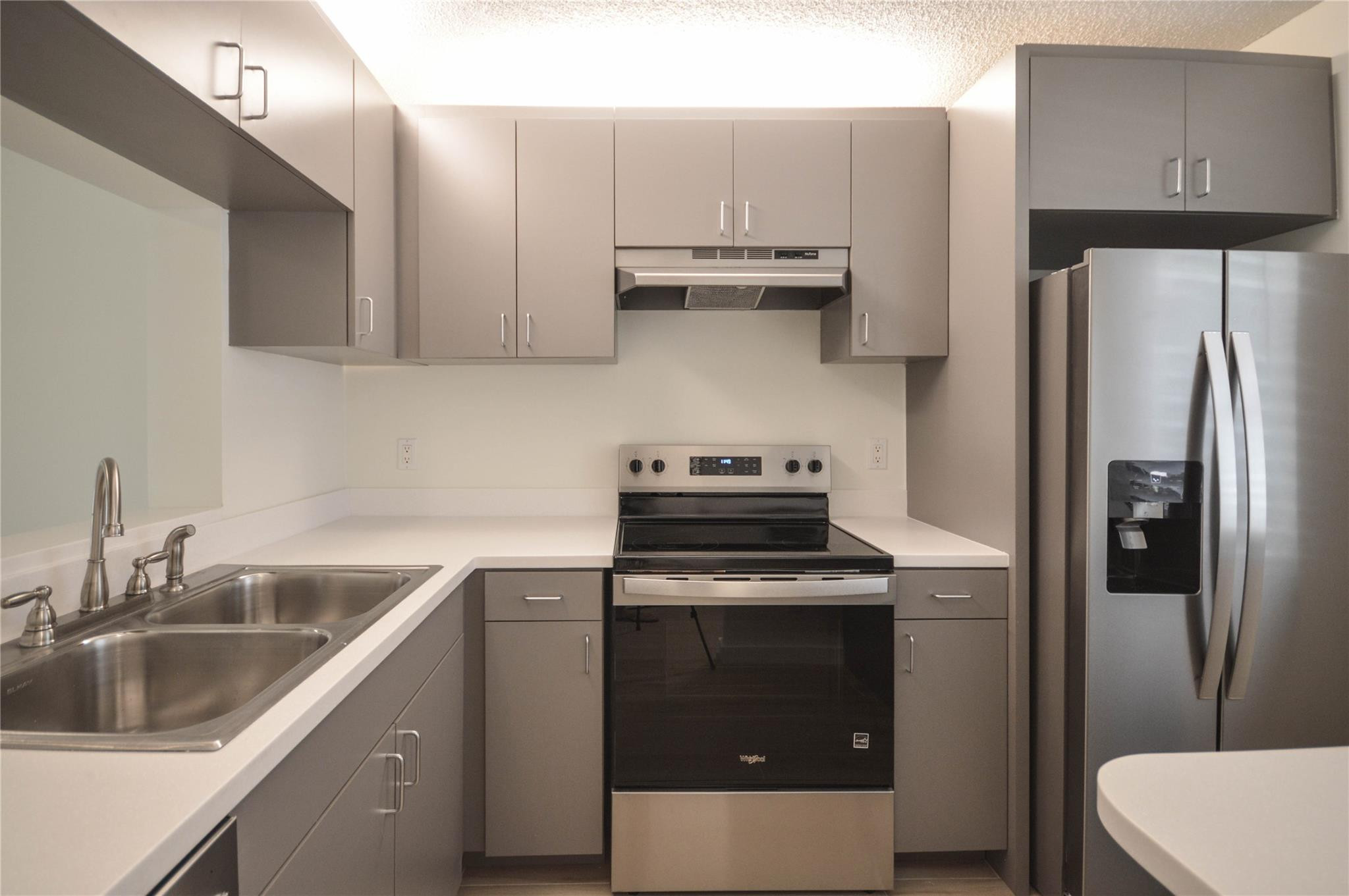 3151 Southeast Aster Lane, Unit 1301 Stuart, FL 34994 - Photo 4 of 30 a kitchen with a sink stove and refrigerator