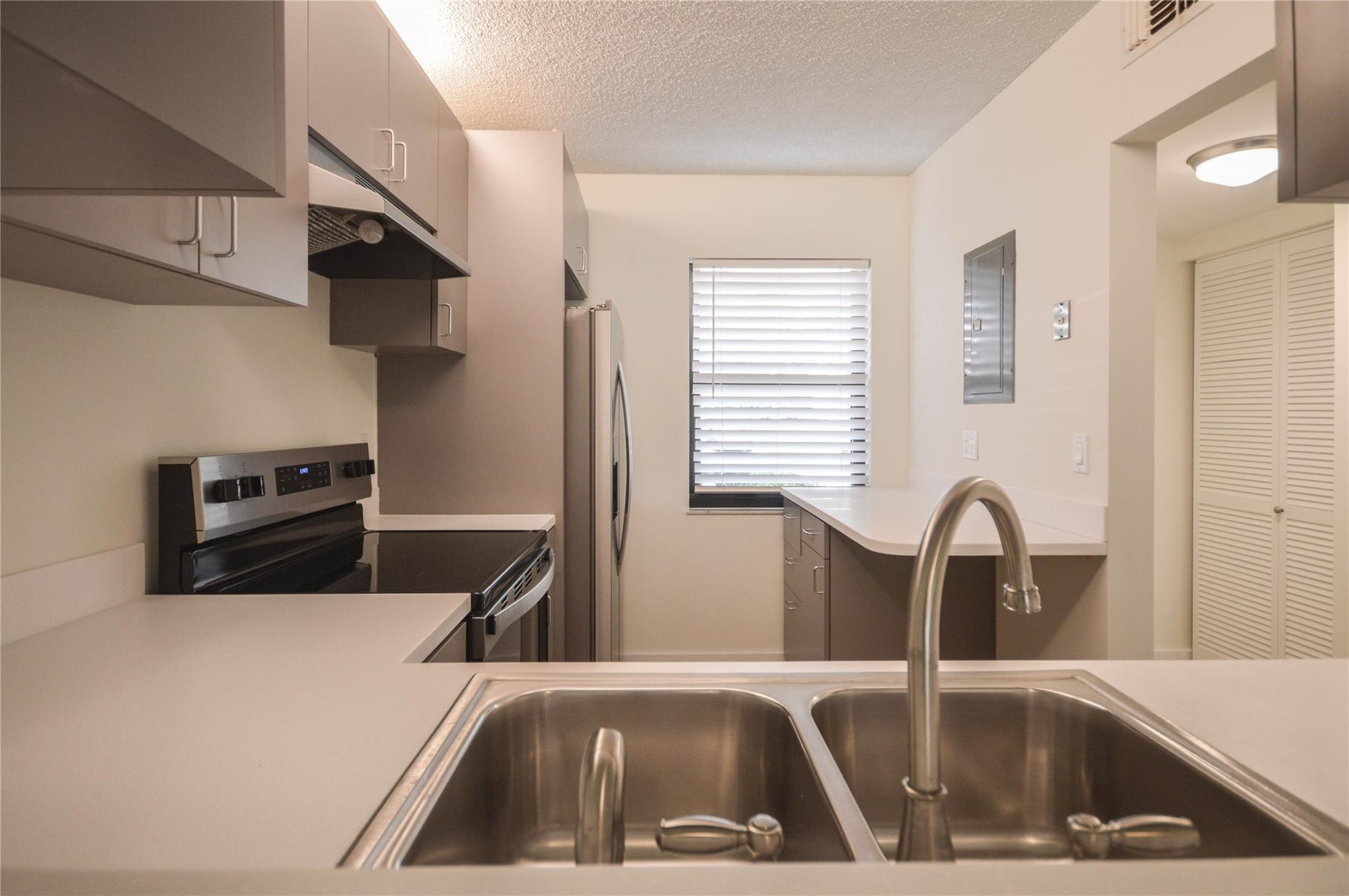 3151 Southeast Aster Lane, Unit 1301 Stuart, FL 34994 - Photo 5 of 30 a kitchen with a sink and a microwave