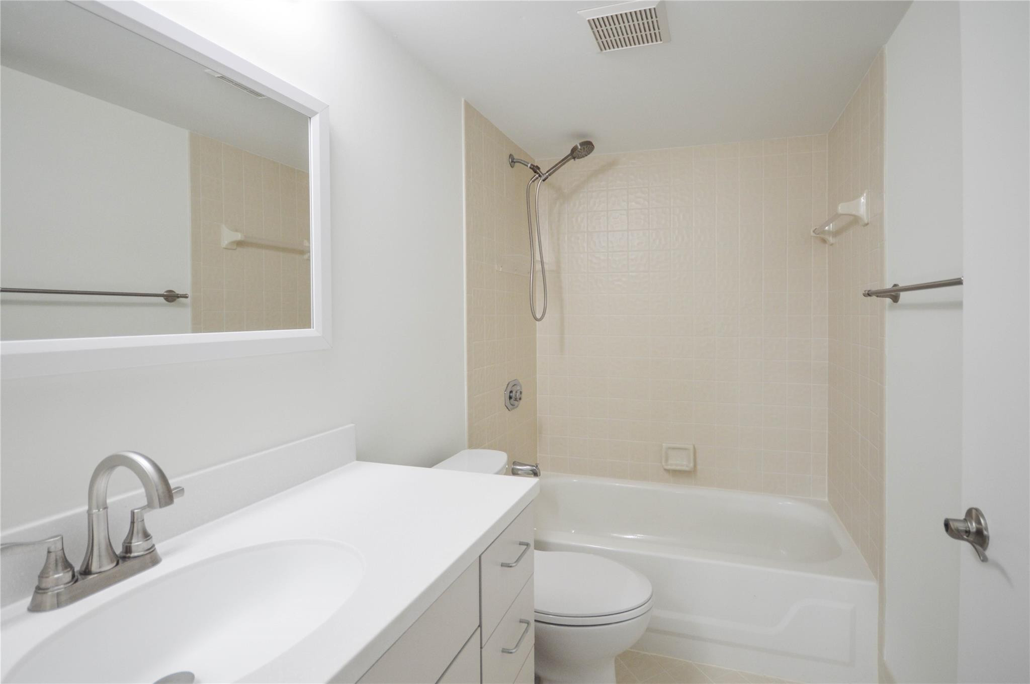 3151 Southeast Aster Lane, Unit 1301 Stuart, FL 34994 - Photo 7 of 30 a bathroom with a sink toilet and shower