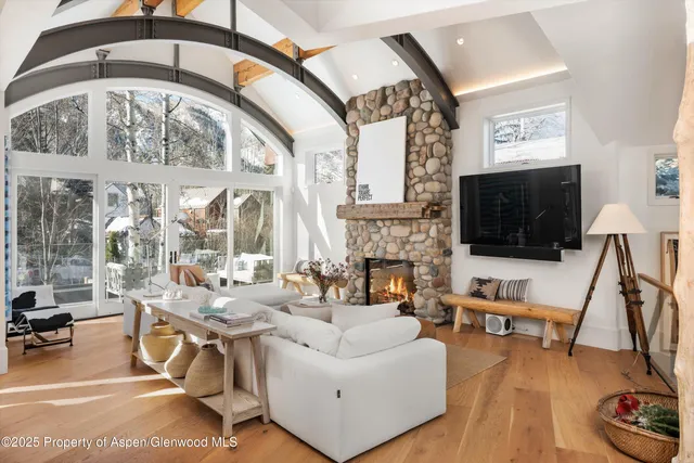 a living room with furniture a flat screen tv and a fireplace