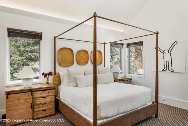 a spacious bathroom with a double vanity sink a large mirror and shower