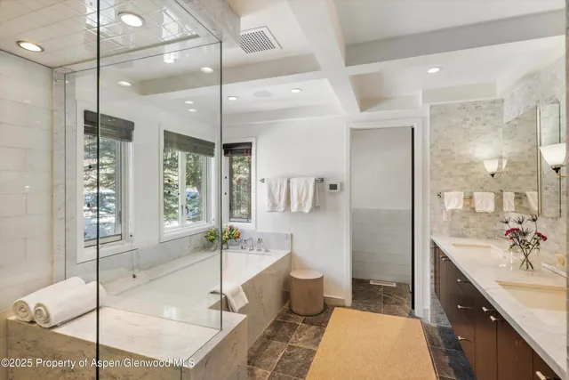 a spacious bathroom with a granite countertop tub sink and shower