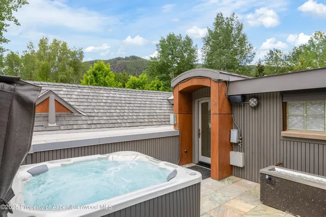 a view of a house with a lush green forest