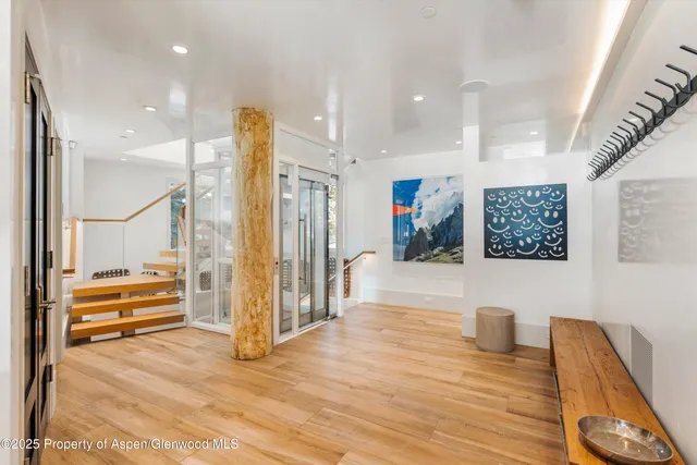 a view of a patio with table and chairs with barbeque and wooden fence