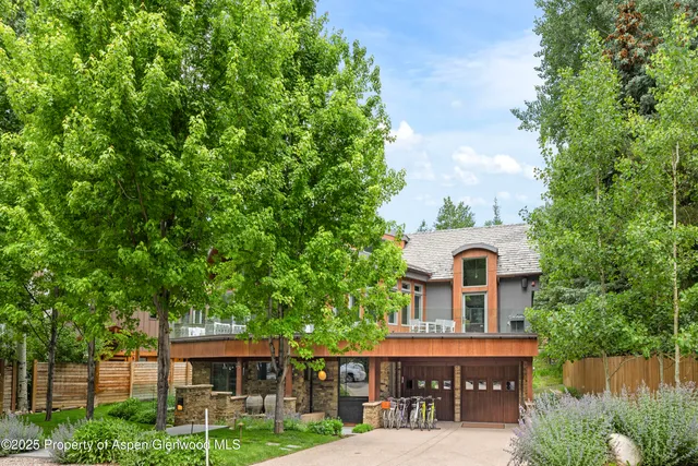 a view of a large building with a tree in the background
