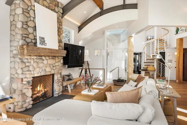 a living room with furniture a fireplace and a flat screen tv