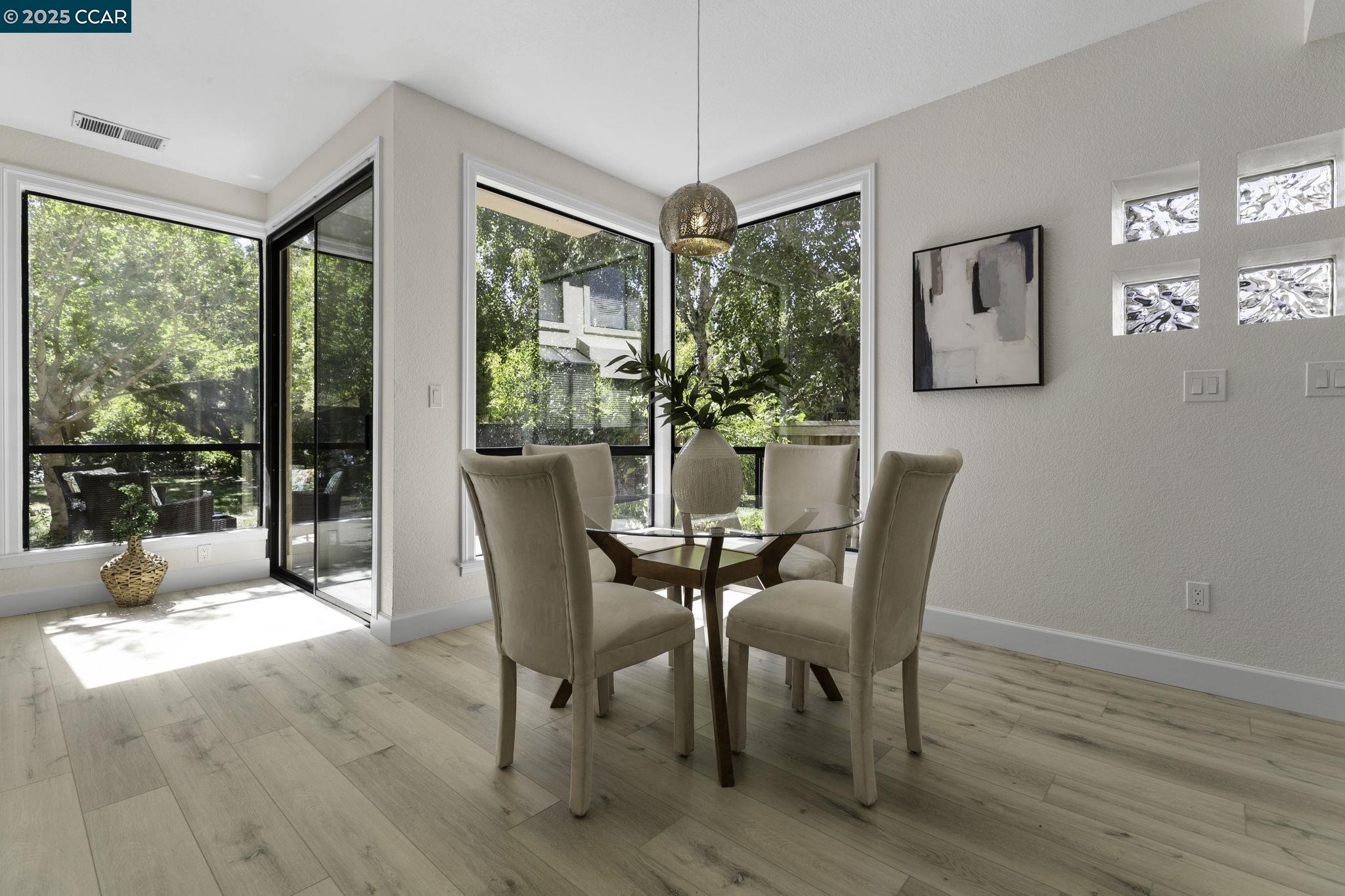 731 Lakemont Place, Unit 7 San Ramon, CA 94582 - Photo 14 of 55 a dining room with furniture a chandelier and wooden floor