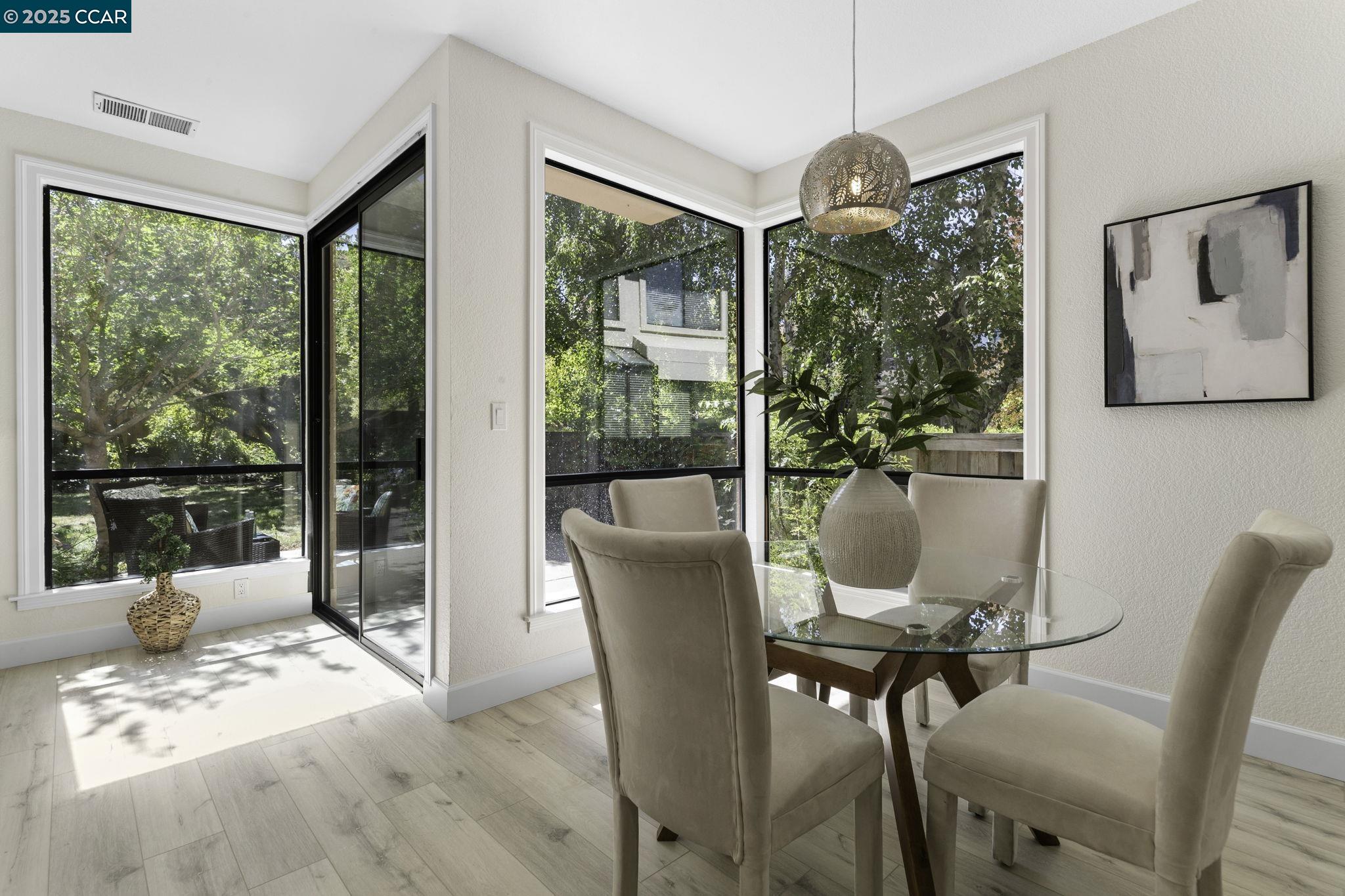 731 Lakemont Place, Unit 7 San Ramon, CA 94582 - Photo 16 of 55 a view of a dining room with furniture large windows and wooden floor