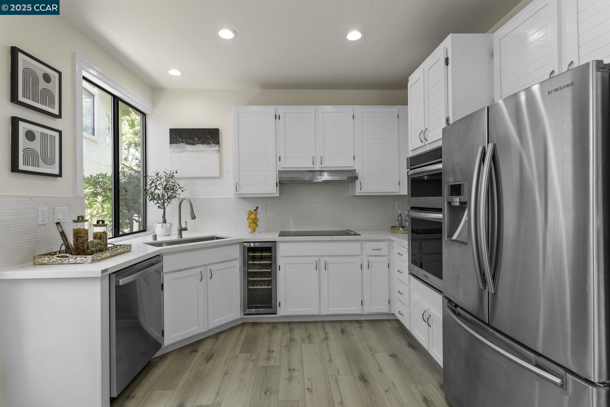 731 Lakemont Place, Unit 7 San Ramon, CA 94582 - Photo 18 of 55 a kitchen with white cabinets and stainless steel appliances