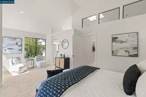 a bedroom with a large bed and a large window