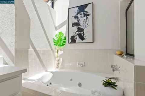a bath tub with a vase and flowers on it