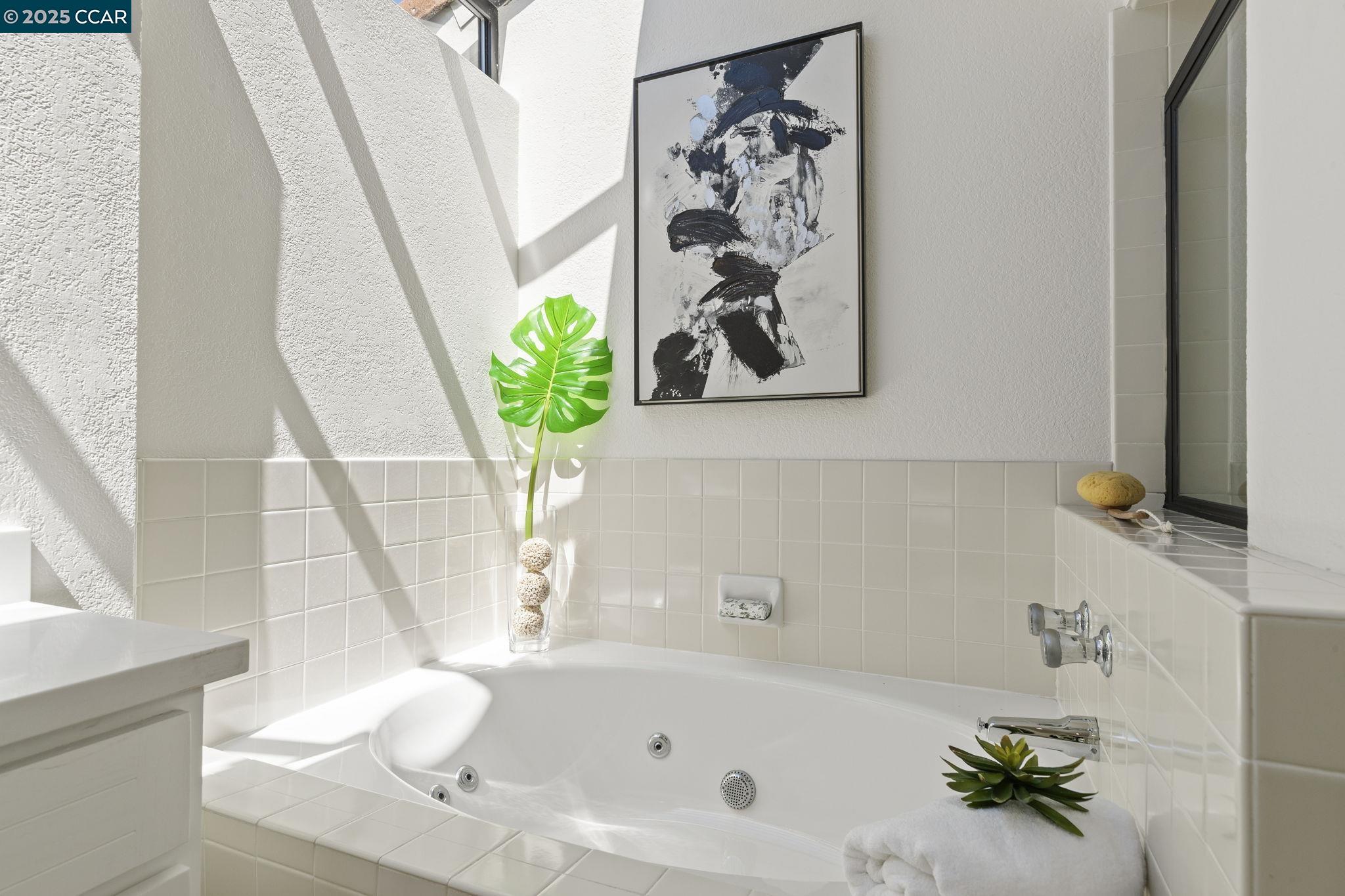 731 Lakemont Place, Unit 7 San Ramon, CA 94582 - Photo 31 of 55 a bath tub with a vase and flowers on it