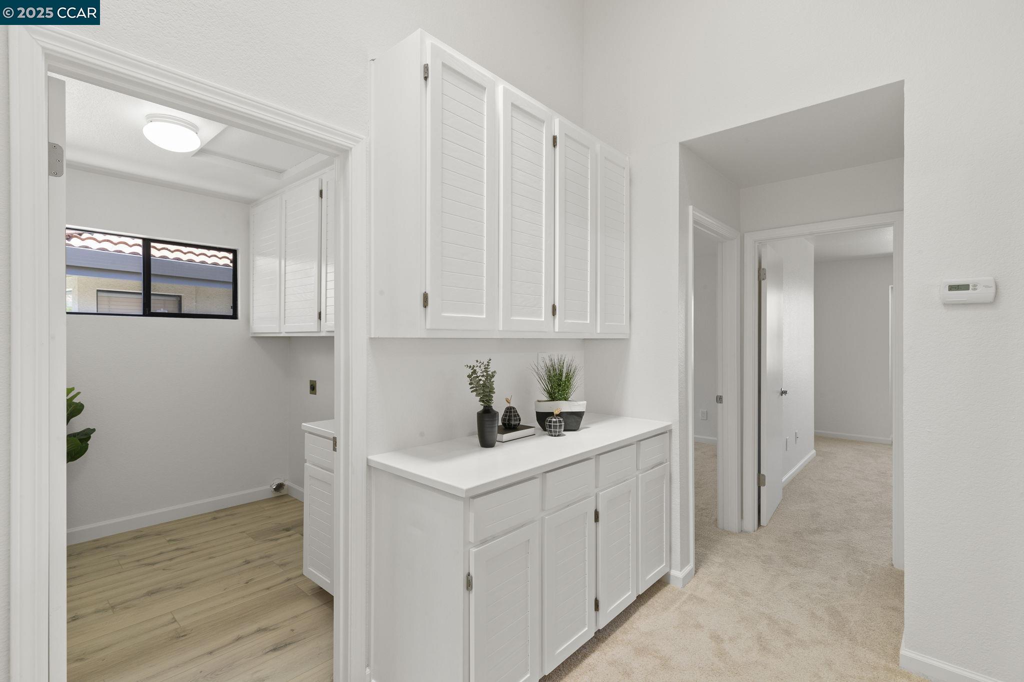 731 Lakemont Place, Unit 7 San Ramon, CA 94582 - Photo 38 of 55 a room with white cabinets and clock on the wall