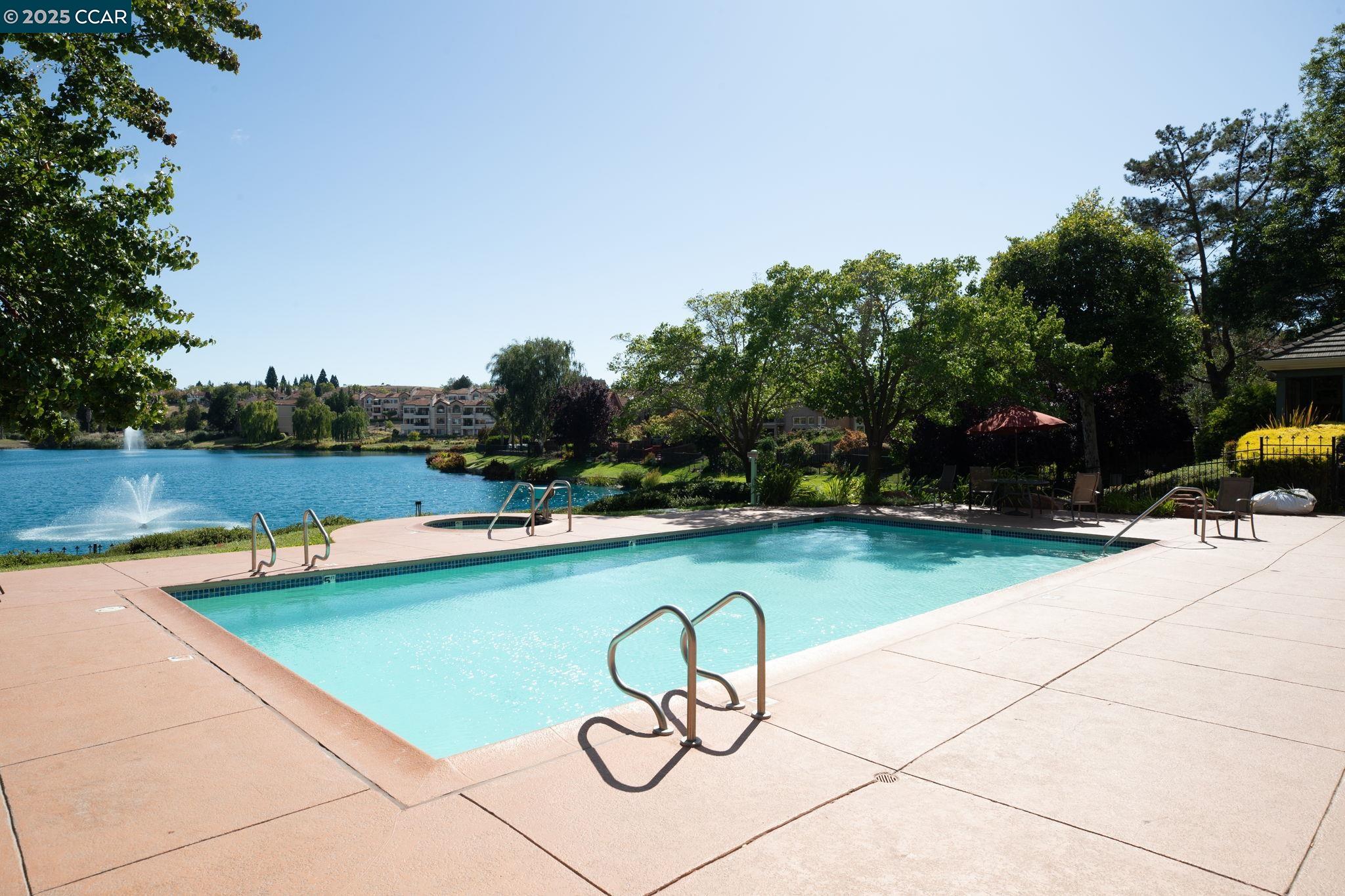 731 Lakemont Place, Unit 7 San Ramon, CA 94582 - Photo 48 of 55 a view of a swimming pool with a lounge chair and trees in the background