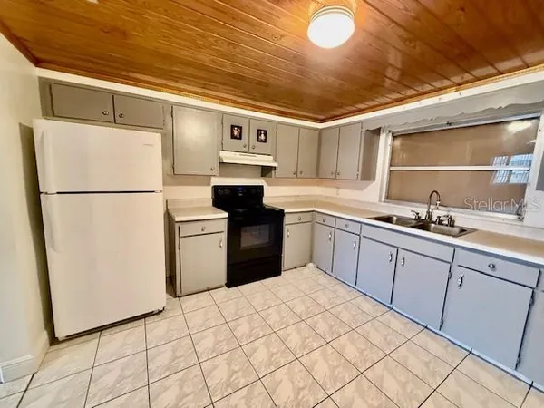 a kitchen with stainless steel appliances granite countertop a refrigerator sink and cabinets