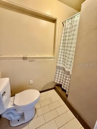 a bathroom with a toilet and a shower