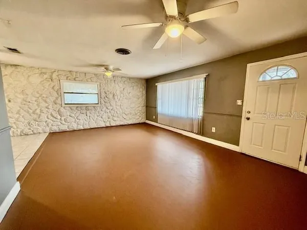 an empty room with a empty space and windows