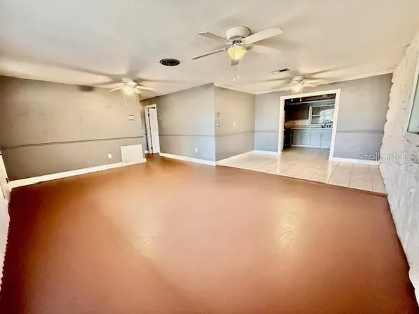 an empty room with a empty space and windows