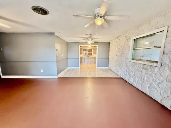 a view of a livingroom with a ceiling fan and wooden floor