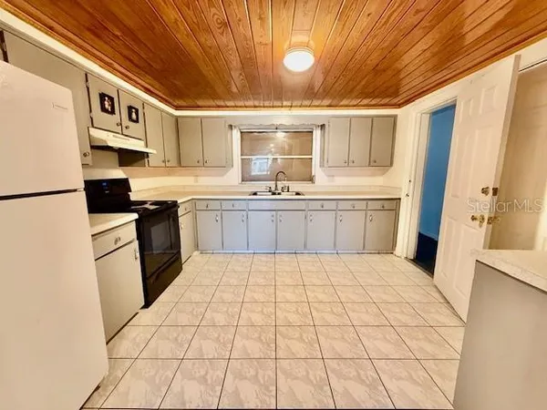 a kitchen with stainless steel appliances granite countertop a sink and cabinets