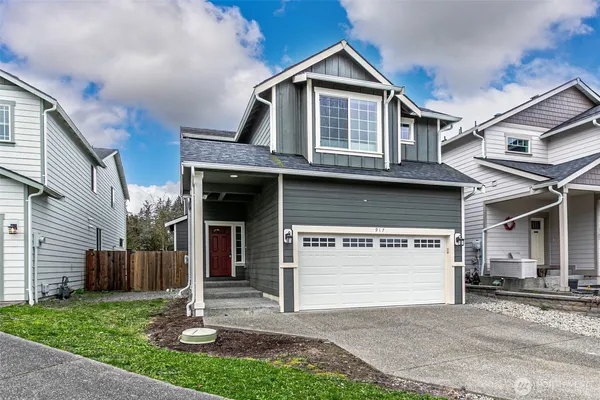 a front view of a house with a yard and garage
