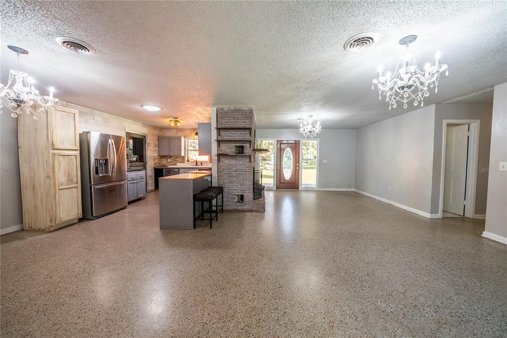 1740 Southeast 164th Circle Ocklawaha, FL 32179 - Photo 13 of 48 a kitchen with stainless steel appliances kitchen island granite countertop a refrigerator and a stove top oven