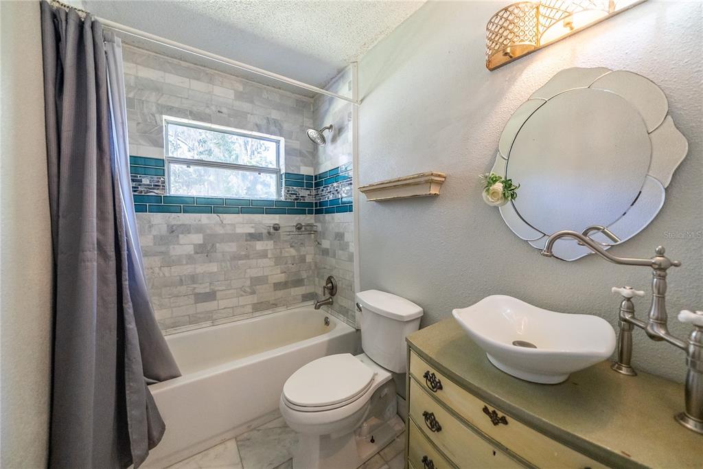 1740 Southeast 164th Circle Ocklawaha, FL 32179 - Photo 15 of 48 a bathroom with a sink and a mirror