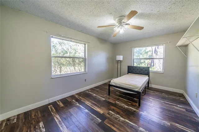 an aerial view of residential house with outdoor space and trees all around