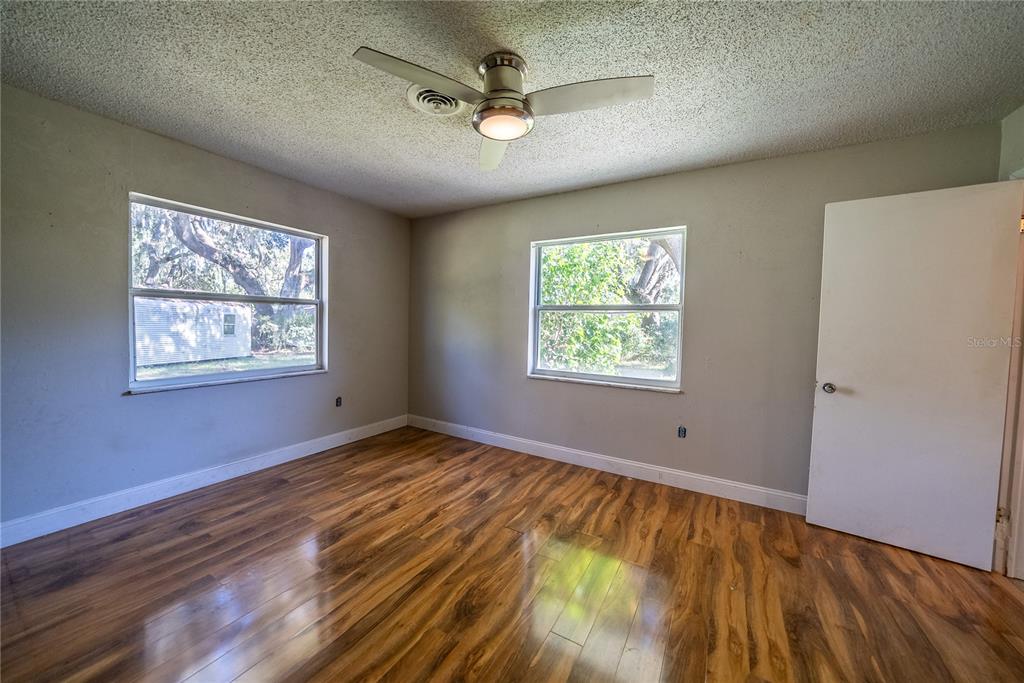 1740 Southeast 164th Circle Ocklawaha, FL 32179 - Photo 19 of 48 a view of an empty room with window and wooden floor