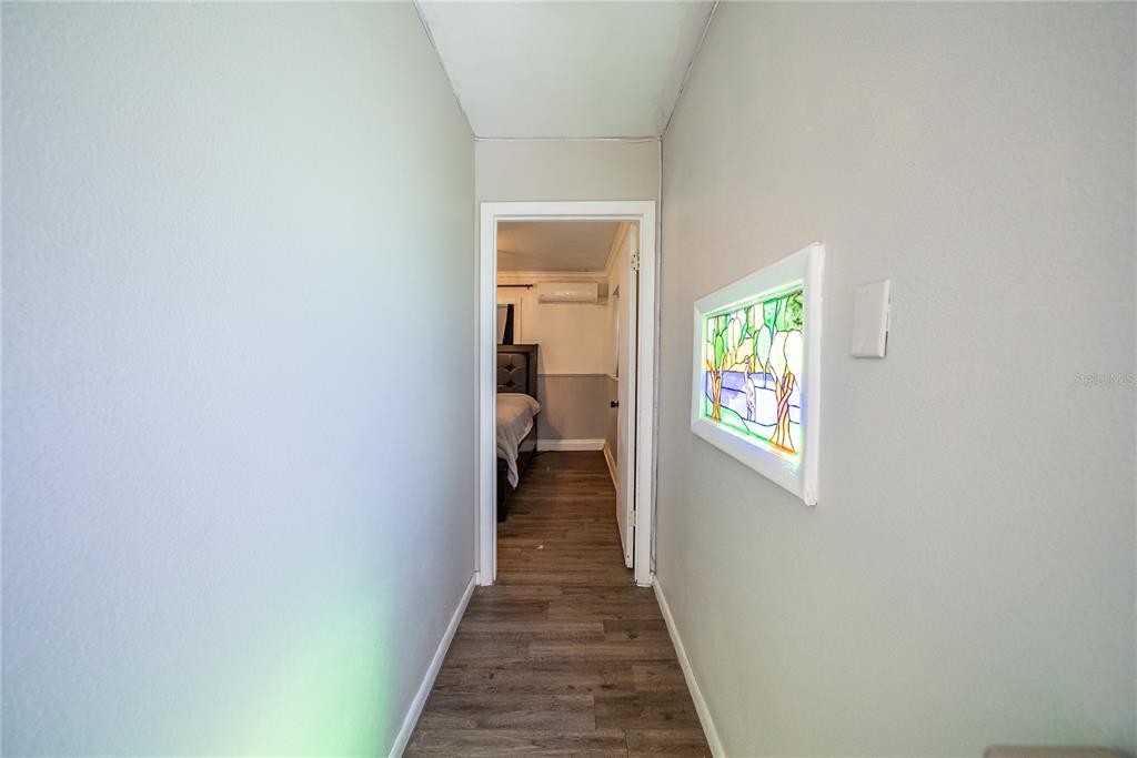 1740 Southeast 164th Circle Ocklawaha, FL 32179 - Photo 29 of 48 a view of a hallway with wooden floor and a window
